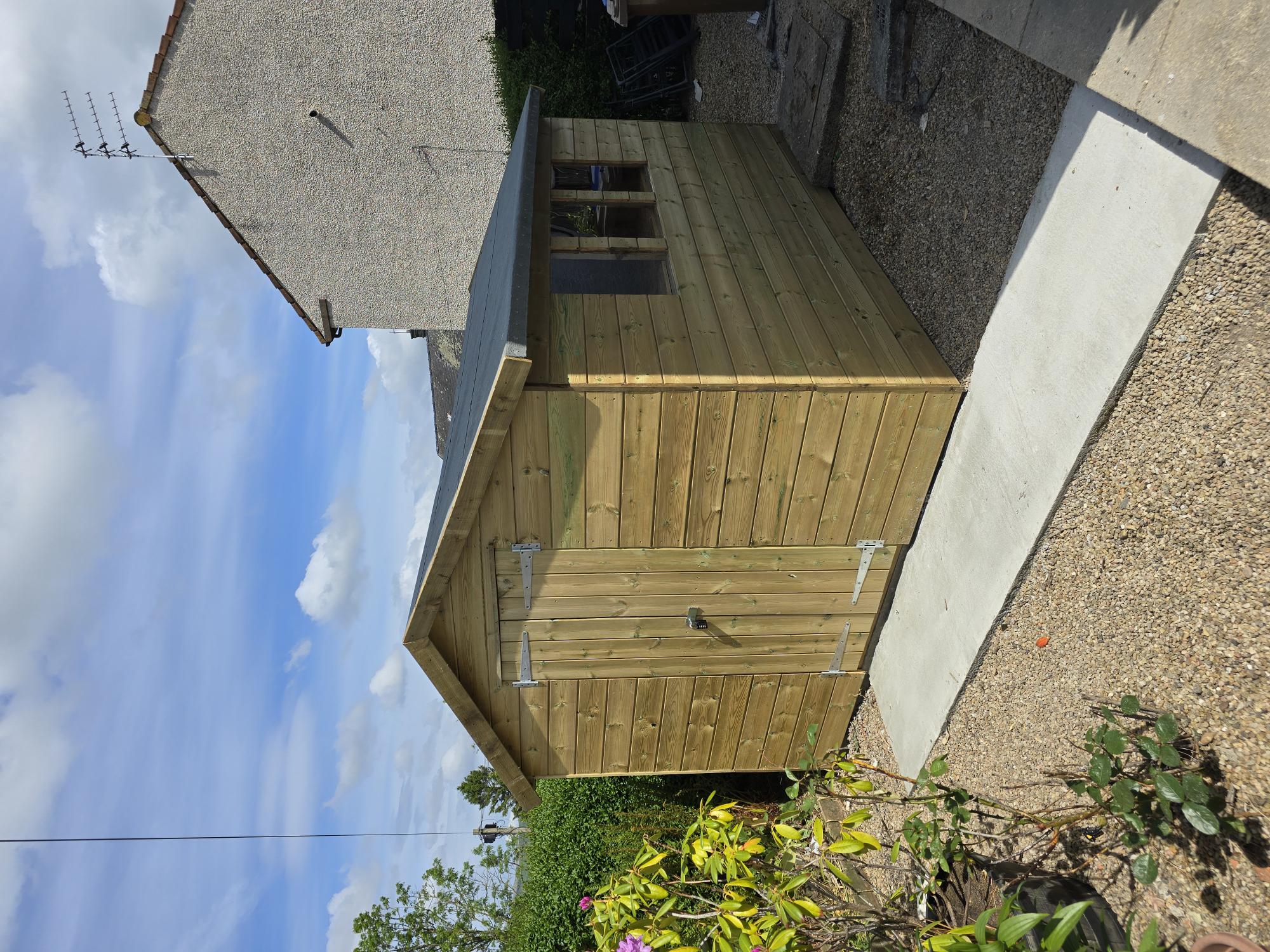 Garden building with decking and gate entrance